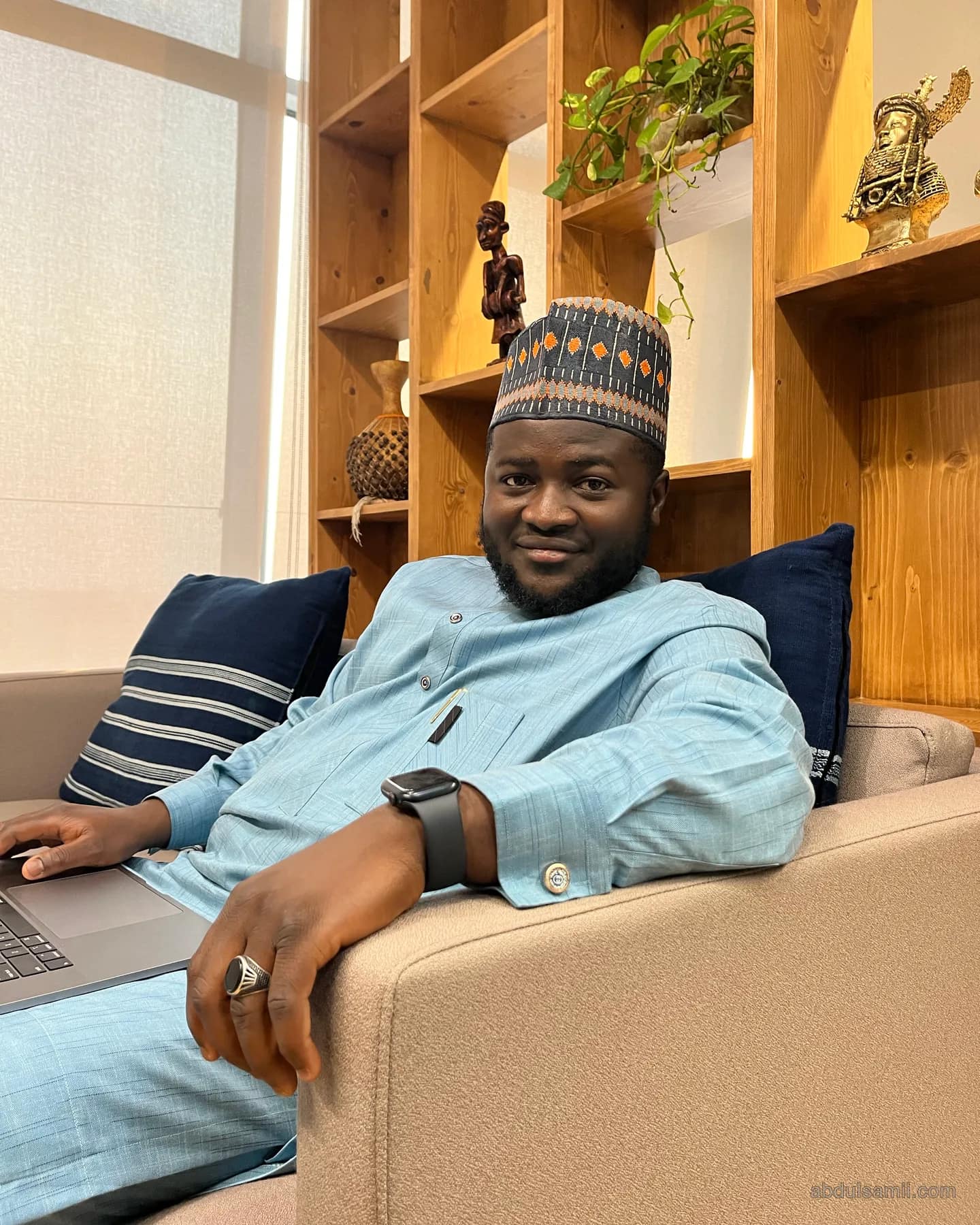 Abdulsamii Ajala working on a laptop in a lounge
