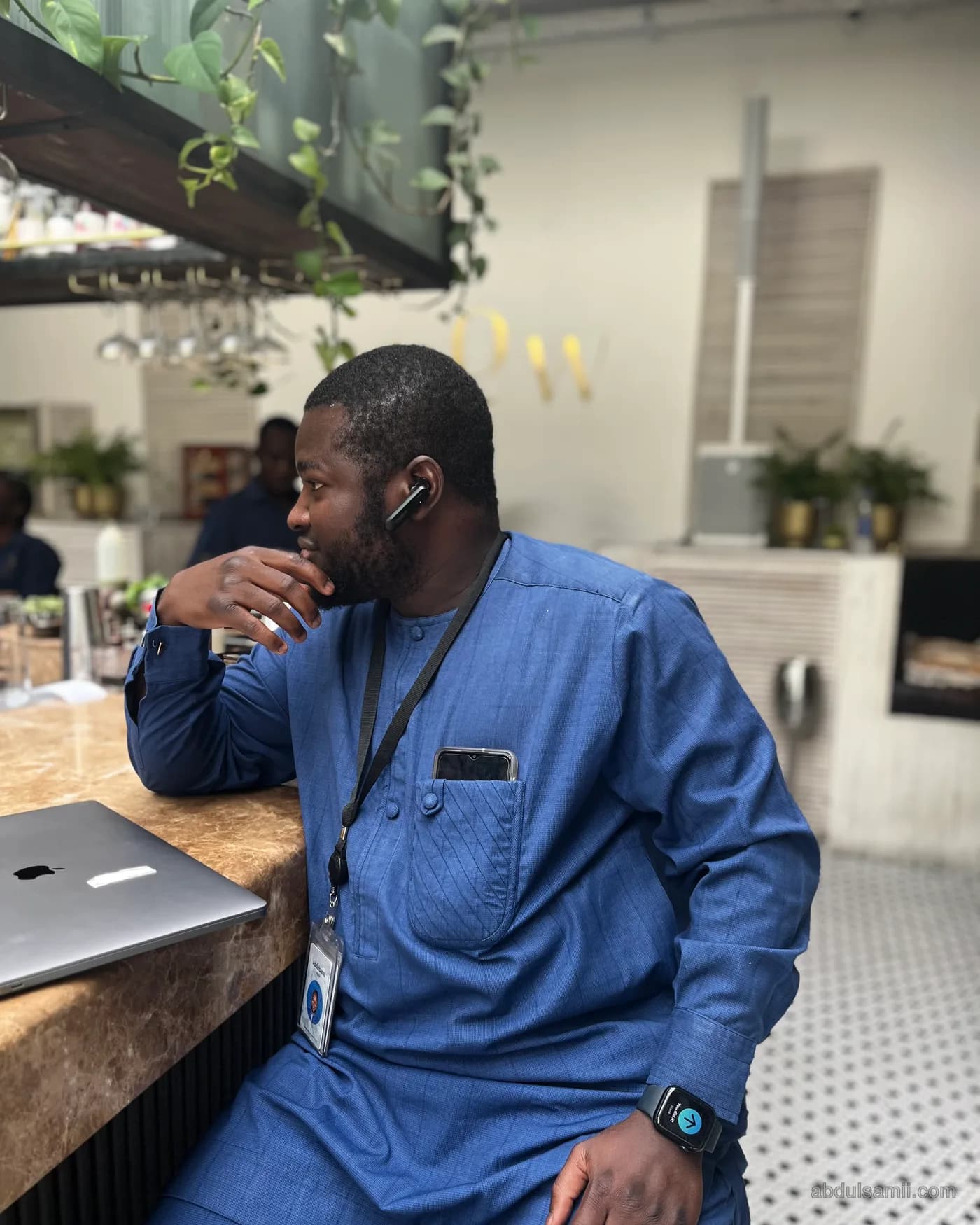 Abdulsamii on a call at a café counter
