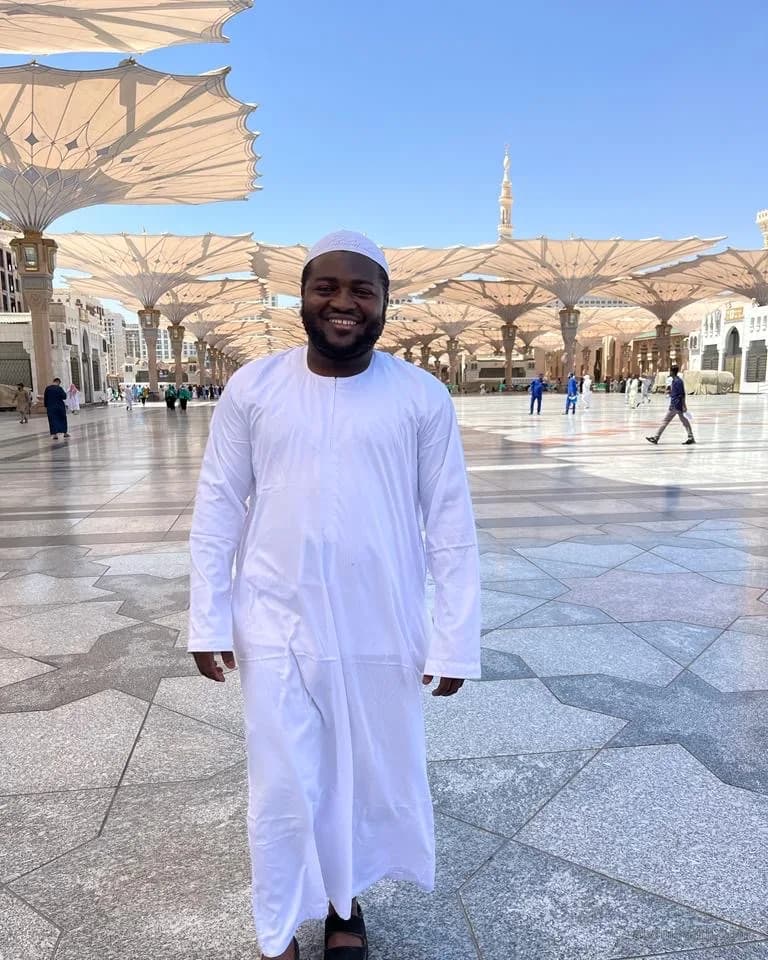 Abdulsamii in white walking across the courtyard in Madinah