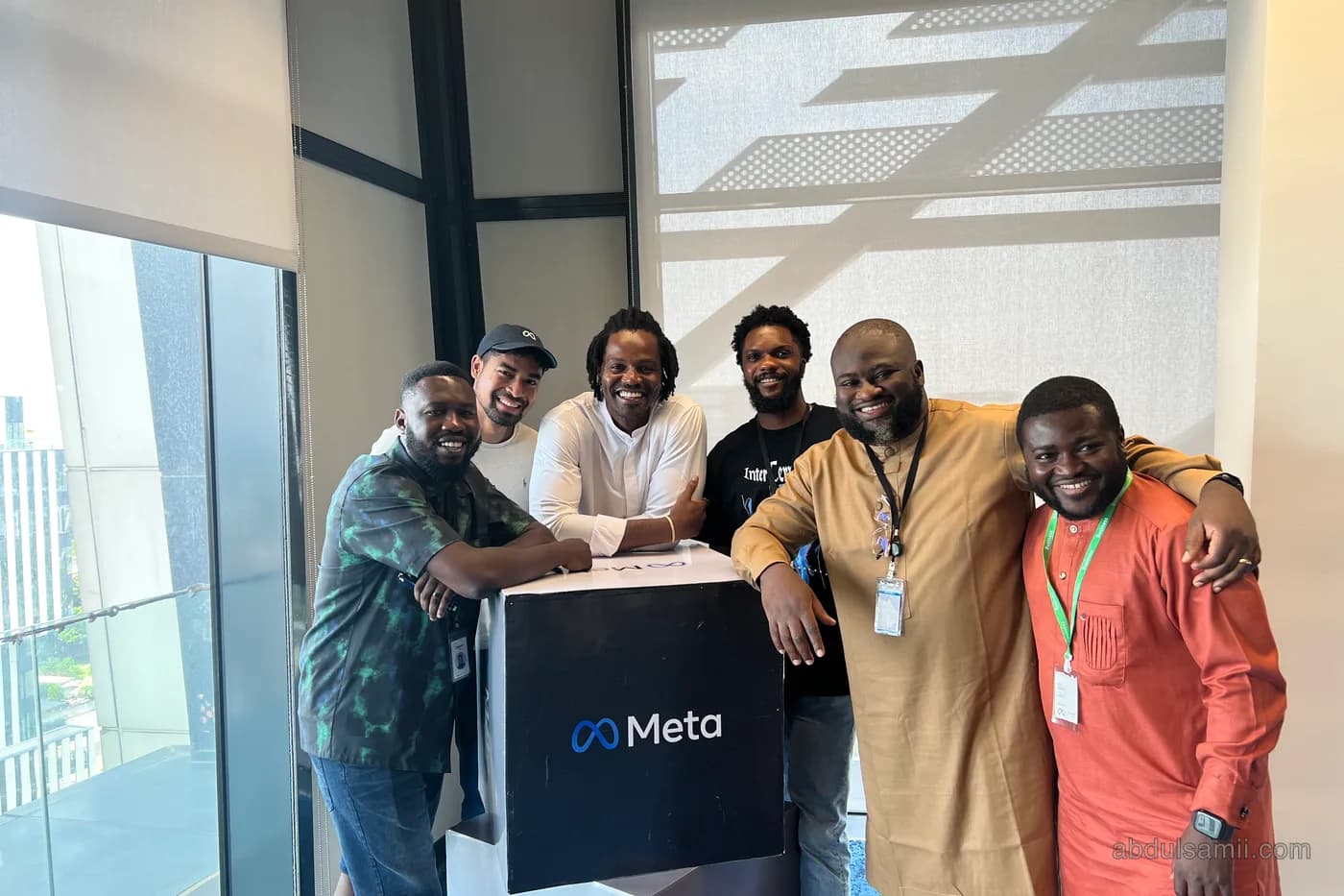 Abdulsamii with the NPE team holding a Meta box