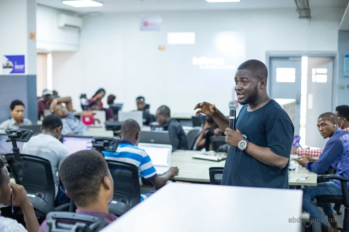 Abdulsamii teaching a room of developers at their laptops